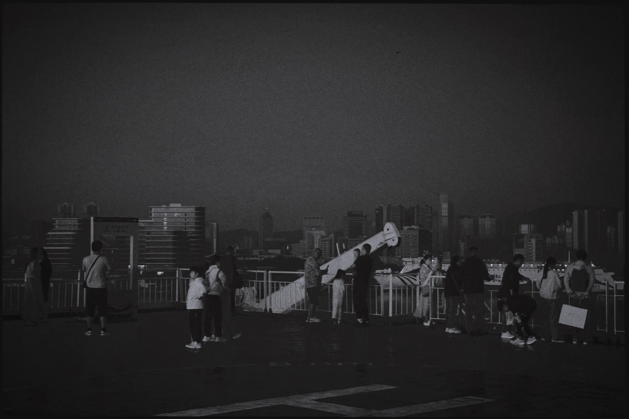 People gathered on a rooftop overlooking Yantai